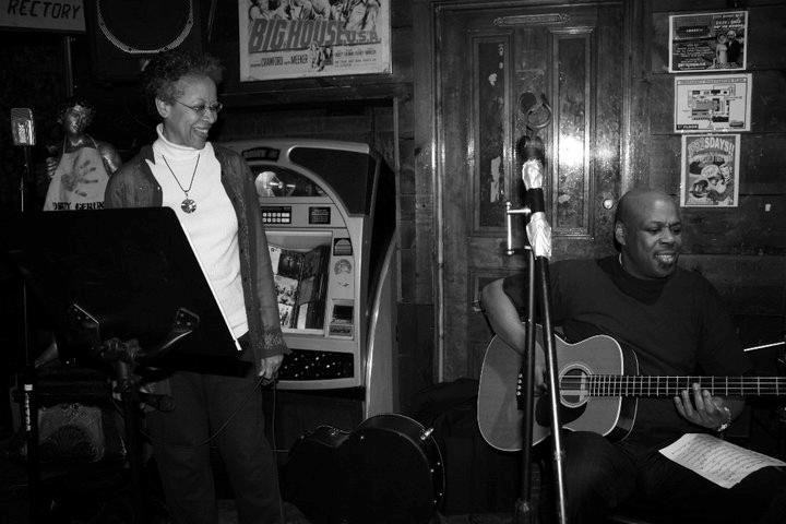 Photo of Charles Ketter playing guitar for an audience